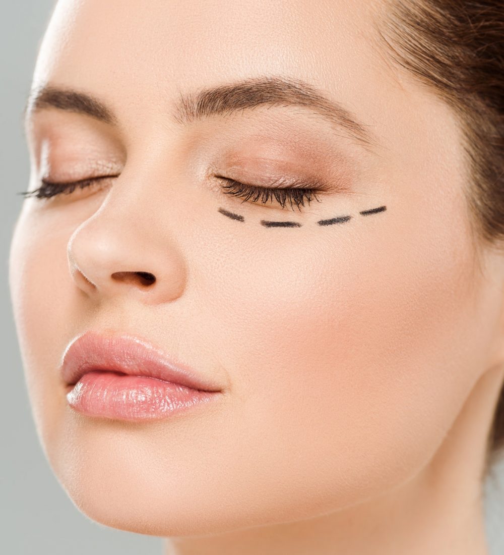 close up view of beautiful woman with closed eyes and marks on face isolated on grey